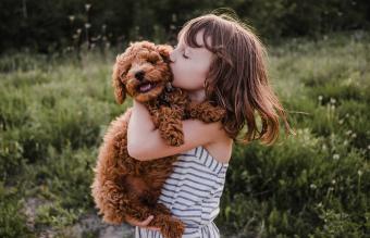 Girl kissing her dog