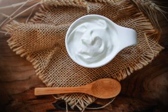 Fresh greek yogurt on rustic background