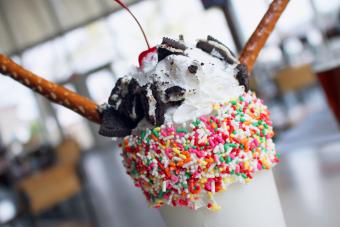 Colossal vanilla milkshake with sprinkles, oreo cookies, pretzels, whipped cream and a cherry