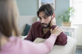 Upset young adults sitting indoors and talking