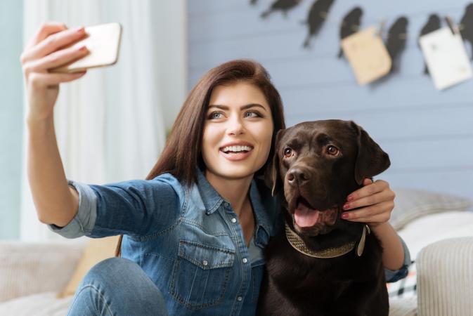 Lady and her dog posing for a photo