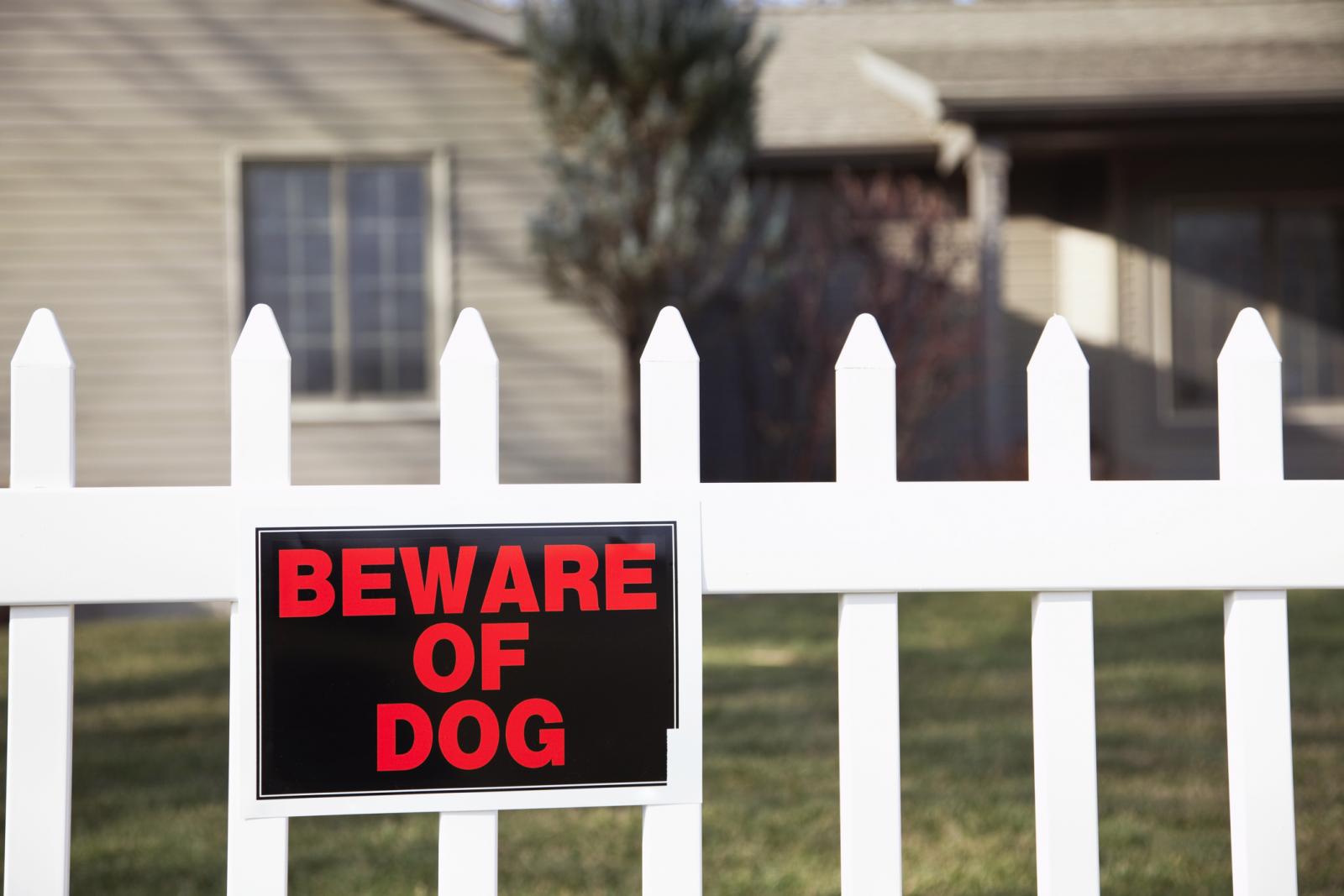 Beware of dog sign on fence