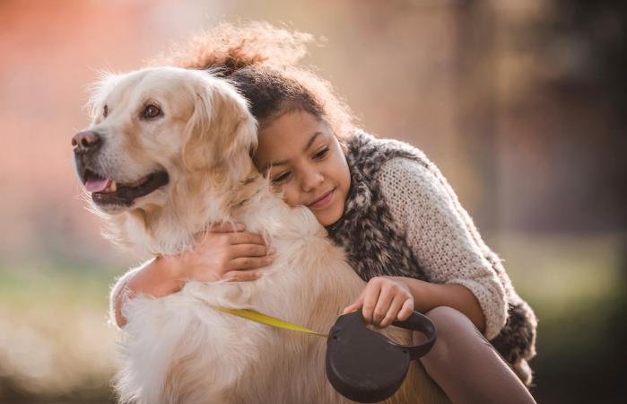 Affectionate girl embracing her dog