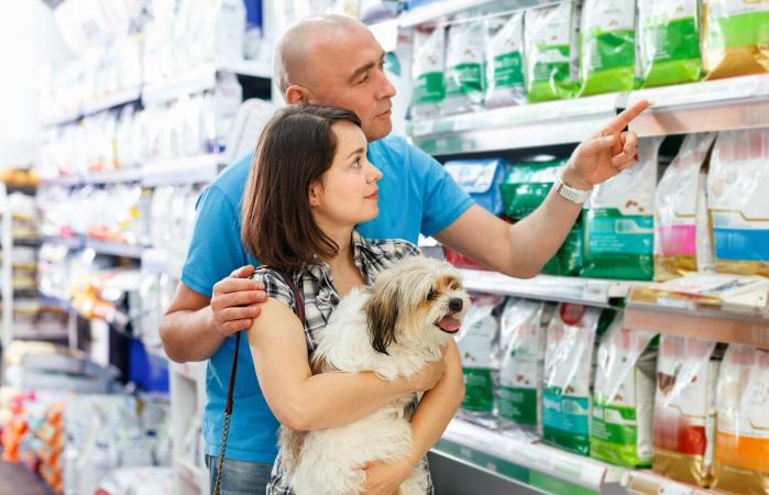 Couple with dog choosing food
