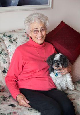 Senior woman sitting with her Shih Tzu