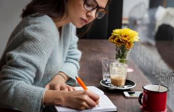 Woman at cafe writing