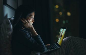 woman in deep thought while using laptop