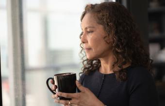 woman drinking tea by window