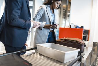 Passengers going through airport scanner and security