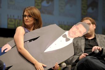 Tina Fey holds a cardboard cut-out of Brad Pitt onstage at the Megamind panel during Comic-Con 2010 - Getty Editorial Use