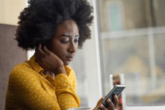 Serious woman using cellphone