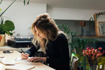 Woman writing letter at home