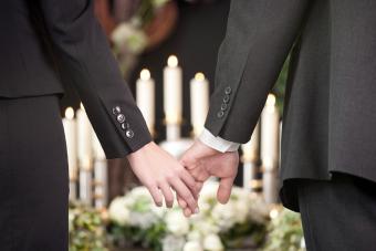 Couple at a funeral holding hands