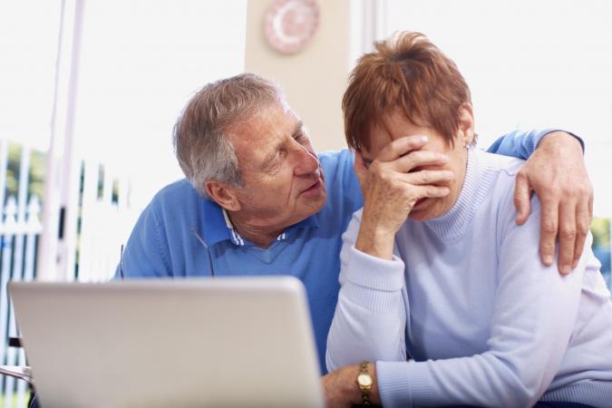 Senior man consoling crying wife