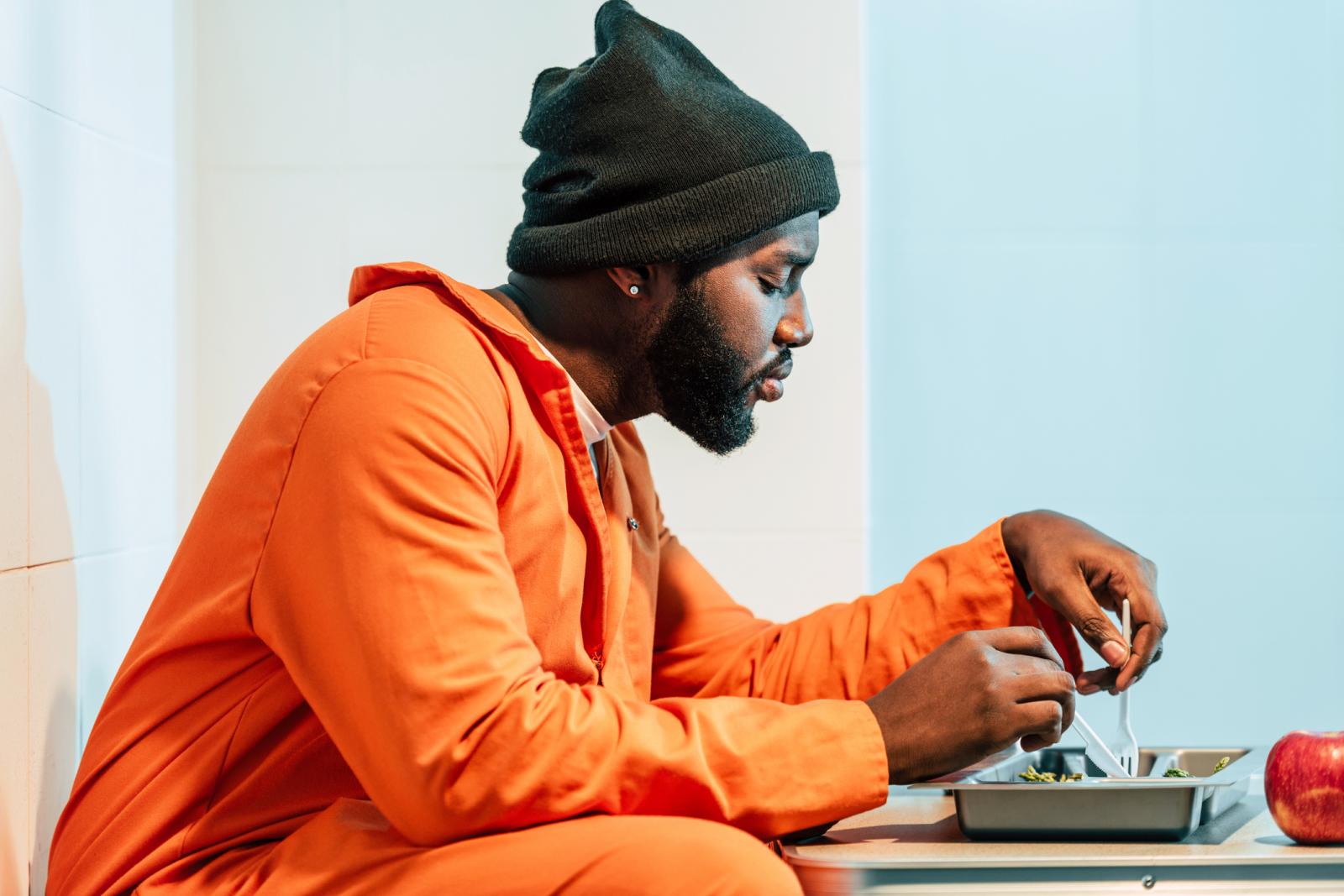 Prisoner eating in prison cell