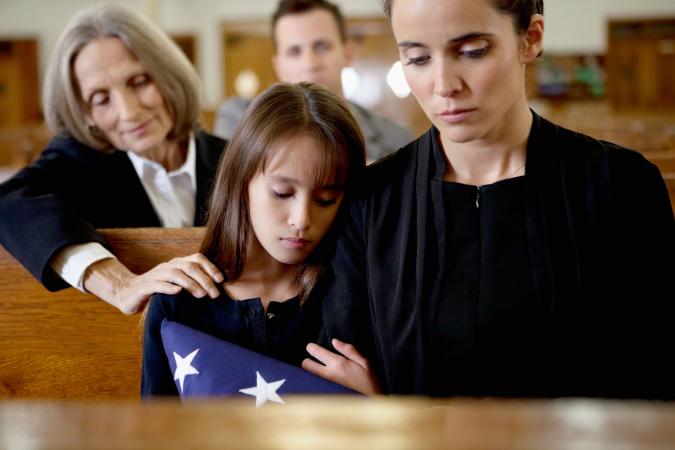 Mother and daughter at military funeral