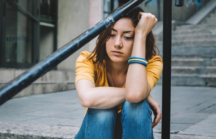 Young woman looking numb with grief