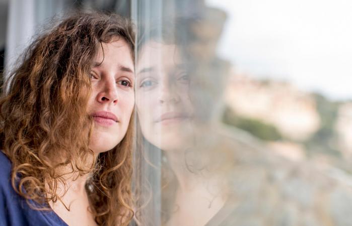 sad woman looking out window