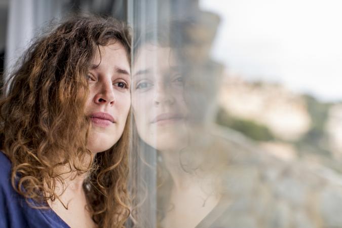 grieving woman looking out window