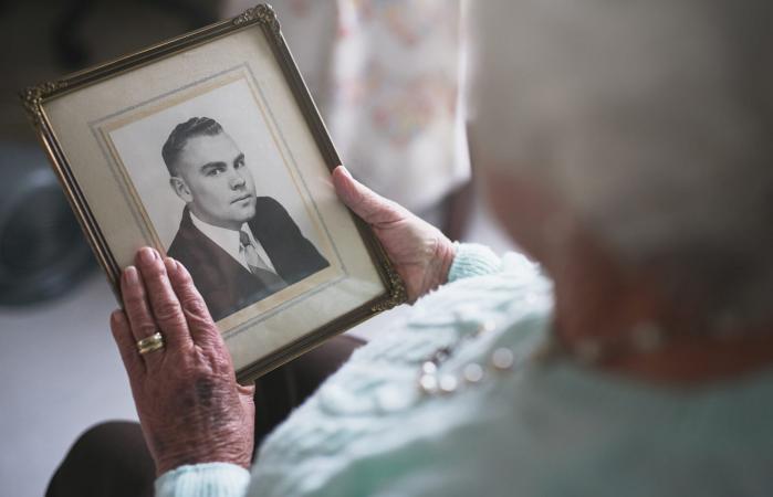 senior woman looking at an old photo