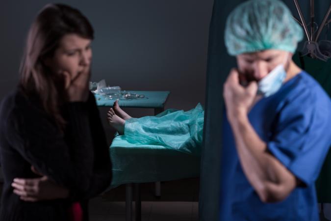 Doctor giving bad news of dead patient