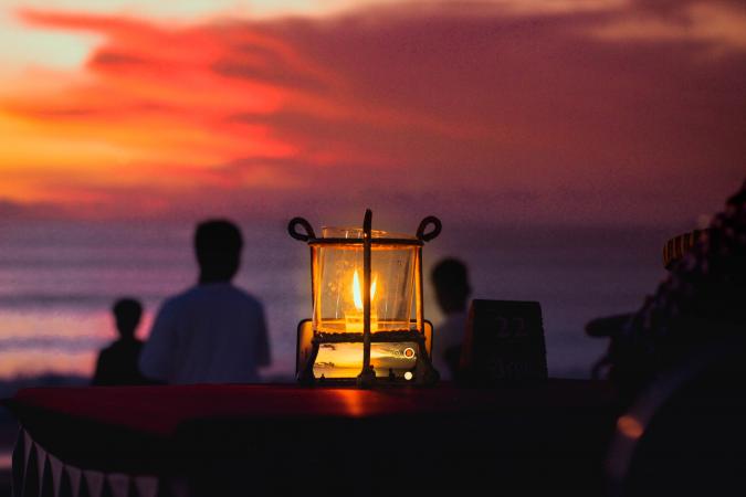 Beach illuminated at sunset by candle
