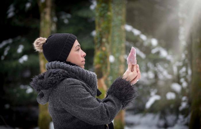 woman is holding a rose quartz