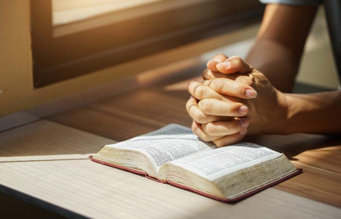 Person reading the Holy Bible