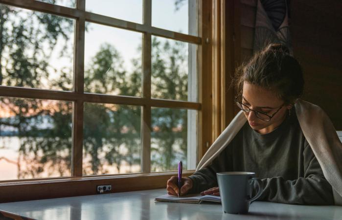 Woman writing into diary