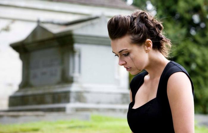 Woman Mourning at Graveyard