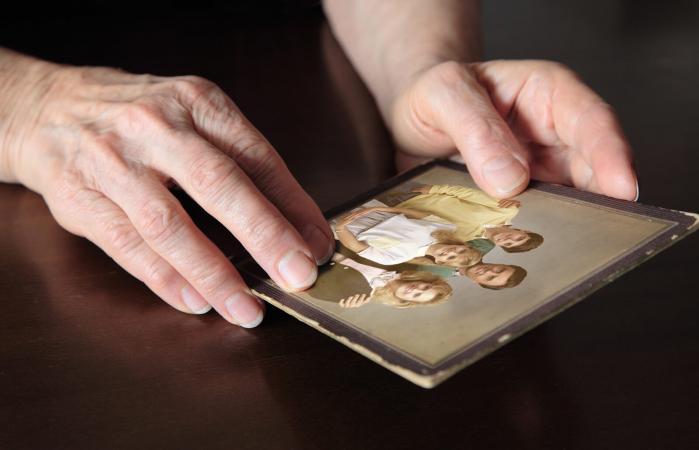 Hands holding an old photo