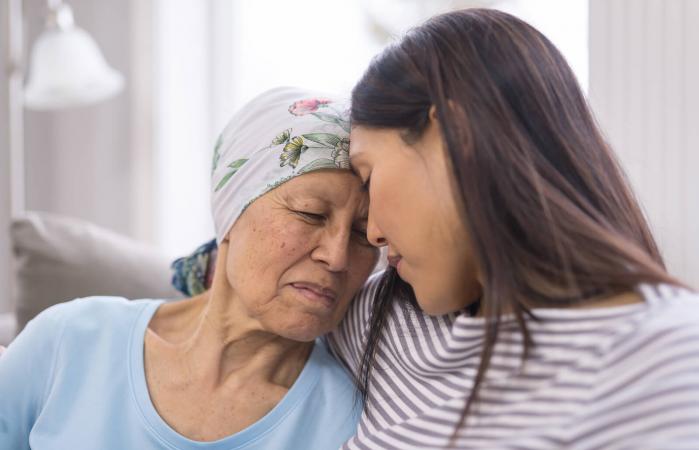 elderly woman embracing her daughter