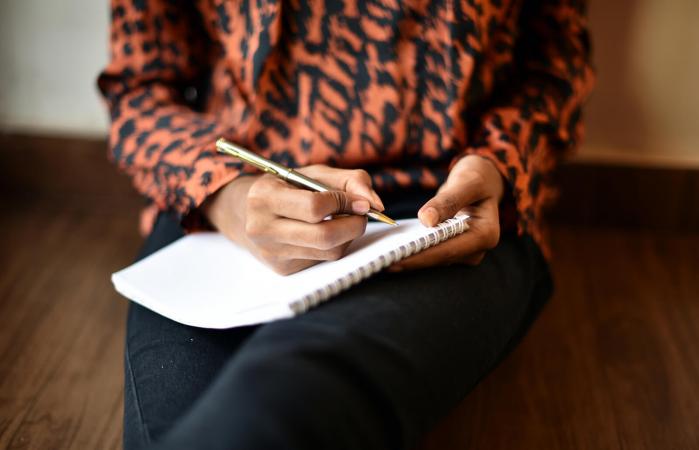 Girl writing on notepad