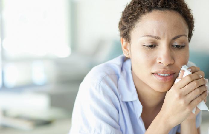Crying woman holding tissue