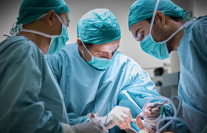 Surgeons operating patient
