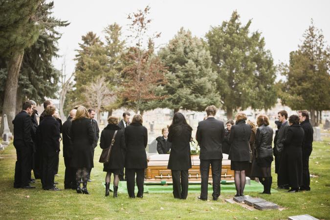 Mourners at a graveside funeral