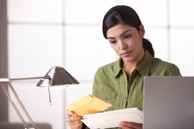 Woman at the office reading a card