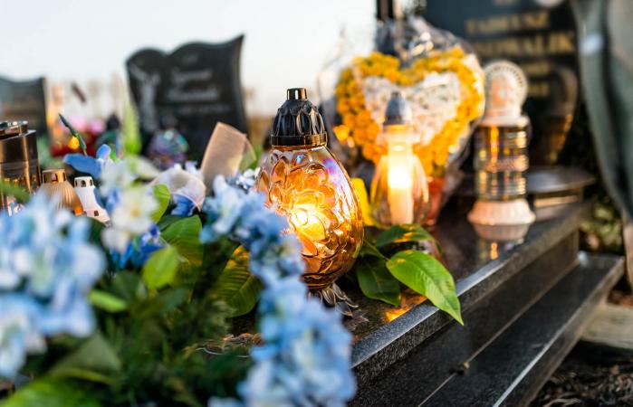 flowers and candlesticks on tombstone