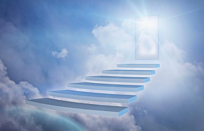 Staircase in clouds with glowing doorway
