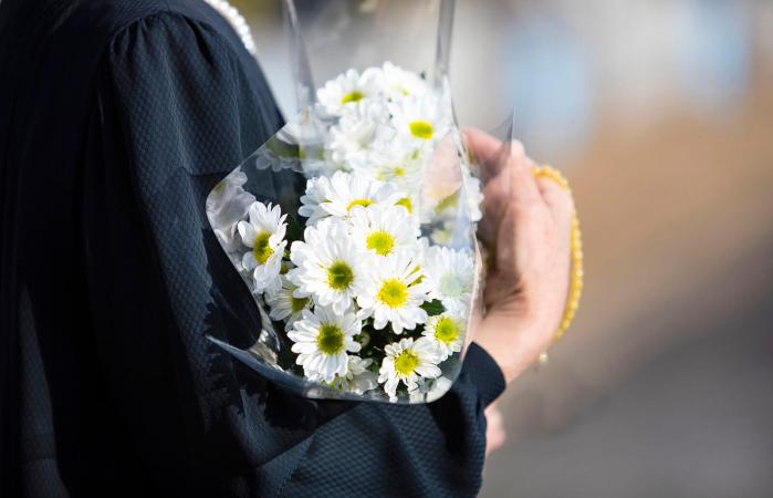 woman with flowers on a funeral