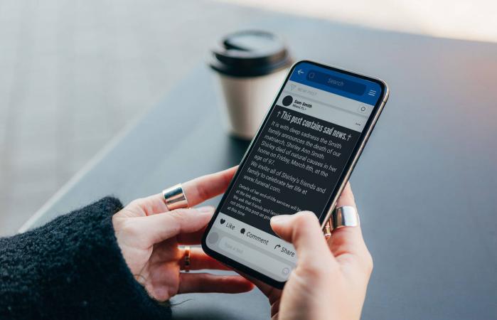 woman writing death announcement on facebook