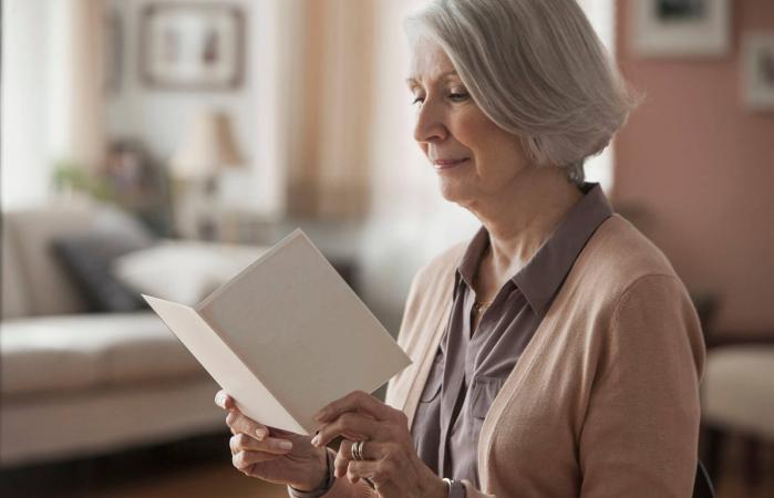 senior woman reading card
