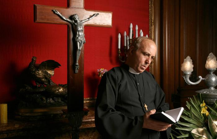 Priest reading from the Bible