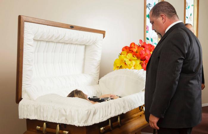 man at funeral viewing