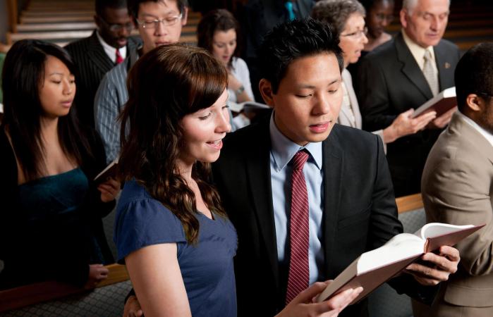 diverse church congregation worshipping together