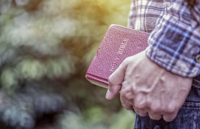 holding the Holy Bible