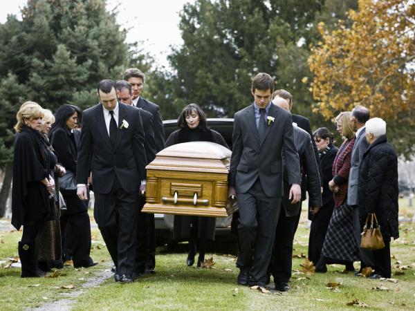 People attending a funeral dressed in black
