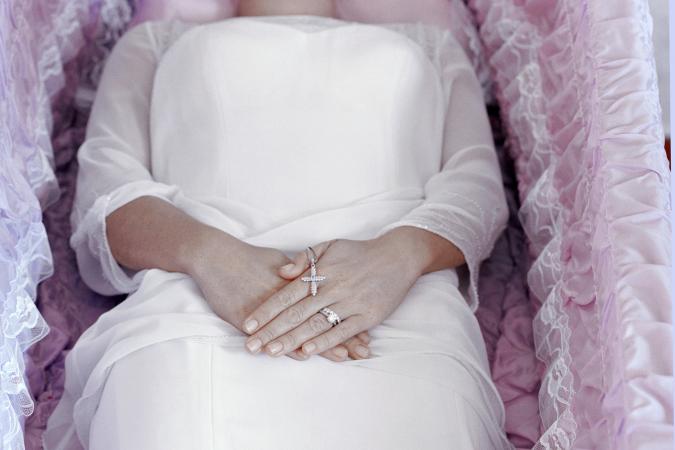 A woman lying in a coffin