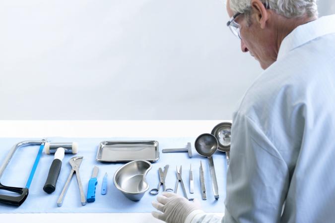 Pathologist preparing for autopsy