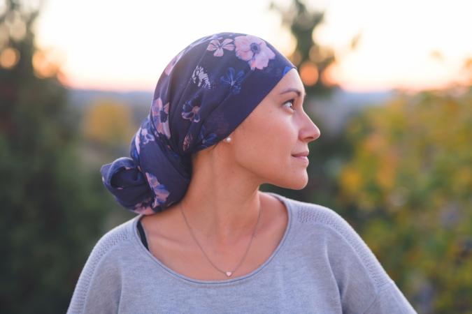 Woman wearing a head wrap smiling